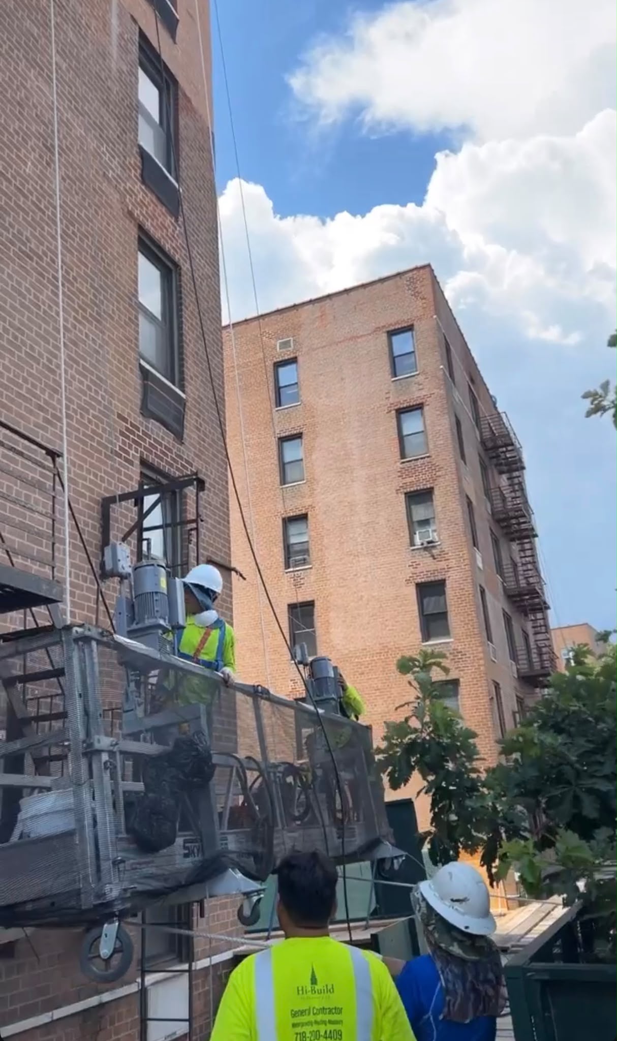 Workers on a suspended facade platform